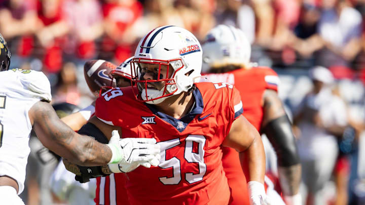 Oct 19, 2024; Tucson, Arizona, USA; Arizona Wildcats offensive lineman Rhino Tapa'atoutai (59) against the Colorado Buffalos at Arizona Stadium. Mandatory Credit: Mark J. Rebilas-Imagn Images Oct 19, 2024; Tucson, Arizona, USA; Arizona Wildcats offensive lineman Rhino Tapa'atoutai (59) against the Colorado Buffalos at Arizona Stadium. Mandatory Credit: Mark J. Rebilas-Imagn Images