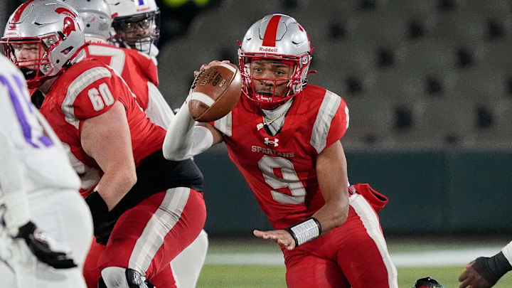 Dec 6, 2024; Birmingham, AL, USA; Saraland's KJ Lacey (9) dashes through a hole in the Parker defense at Protective Stadium in the 6A State Championship game.