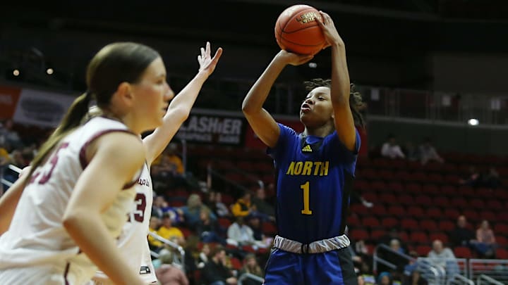 Davenport North's guard Divine Bourrage (1) takes a shot around Dowling Catholic during the third quarter in the 5A high girls state quarterfinal at Wells Fargo Arena Monday, Feb. 27, 2023, in Des Moines, Iowa. Davenport North's guard Divine Bourrage (1) takes a shot around Dowling Catholic during the third quarter in the 5A high girls state quarterfinal at Wells Fargo Arena Monday, Feb. 27, 2023, in Des Moines, Iowa.