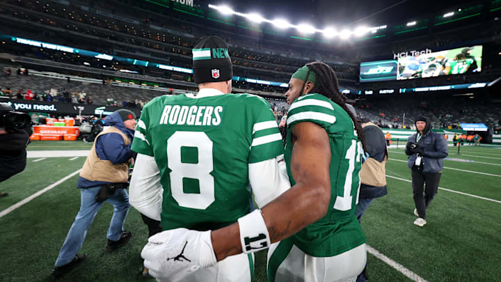 Jan 5, 2025; East Rutherford, New Jersey, USA; New York Jets quarterback Aaron Rodgers (8) and wide receiver Davante Adams (17) walk on the field after the Jets win over the Miami Dolphins at MetLife Stadium. Mandatory Credit: Ed Mulholland-Imagn Images