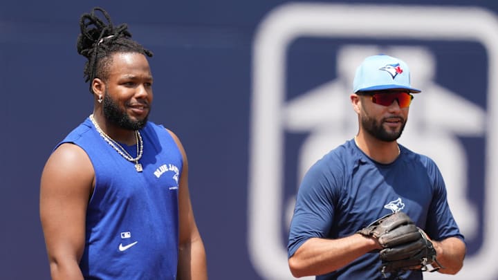 May 20, 2024; Toronto, Ontario, CAN; Toronto Blue Jays first base Vladimir Guerrero Jr. (27) and third baseman Isiah Kiner-Falefa (7) take a break during batting practice before a game against the Chicago White Sox at Rogers Centre. Mandatory Credit: Nick Turchiaro-USA TODAY Sports