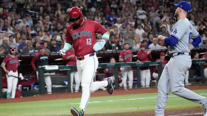 Arizona Diamondbacks outfielder Lourdes Gurriel Jr. (12) scores after a wild pitch by Los Angeles