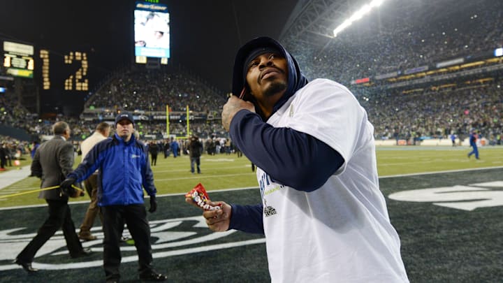 Seattle Seahawks running back Marshawn Lynch throws Skittles into the crowd after the 2013 NFC Championship.