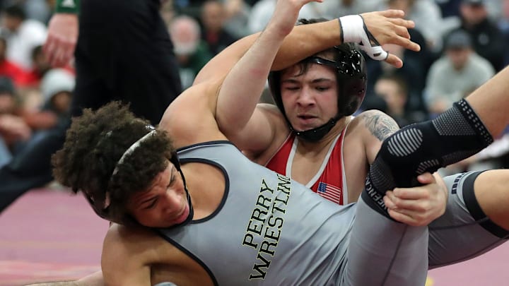 Joseph Sanderfer of Massillon Perry (foreground) wrestles Bo Bassett of Bishop McCort during their 144 pound semifinal match during the 2024 Ironman Wrestling Tournament at Walsh Jesuit High School on Saturday, Dec. 7, 2024. Bassett won the match and went to capture the 144 pound title. Joseph Sanderfer of Massillon Perry (foreground) wrestles Bo Bassett of Bishop McCort during their 144 pound semifinal match during the 2024 Ironman Wrestling Tournament at Walsh Jesuit High School on Saturday, Dec. 7, 2024. Bassett won the match and went to capture the 144 pound title.
