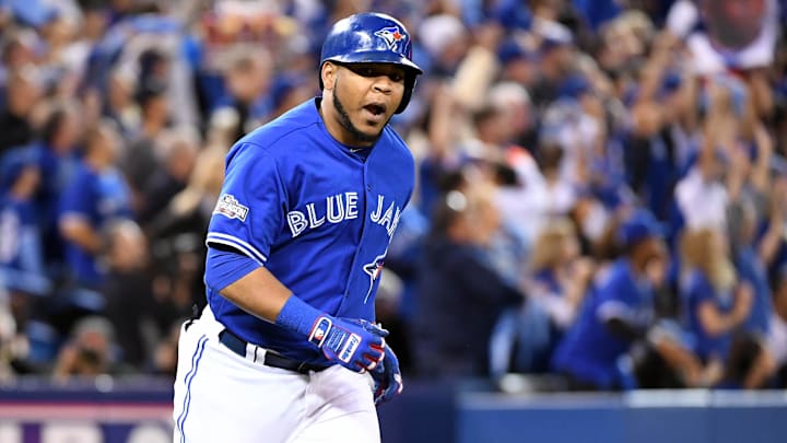 Toronto Blue Jays slugger Edwin Encarnacion cheers while running the bases in a blue jersey, blue helmet and white pants.