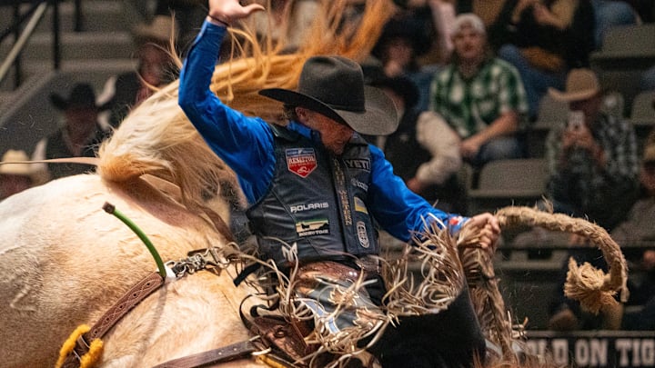 Rusty Wright of Milford, Utah, participates in saddle bronc riding 
