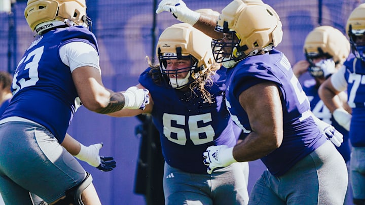 Landen Hatchett (66) mixes it up with Paki Finau, left, and Michael Levelle Watkins in spring ball.