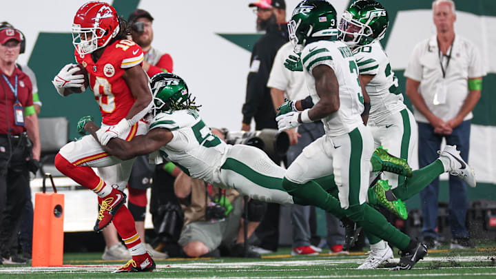 Oct 1, 2023; East Rutherford, New Jersey, USA; Kansas City Chiefs running back Isiah Pacheco (10) fights for yards as New York Jets linebacker Quincy Williams (56) tackles during the second half at MetLife Stadium. Mandatory Credit: Vincent Carchietta-Imagn Images
