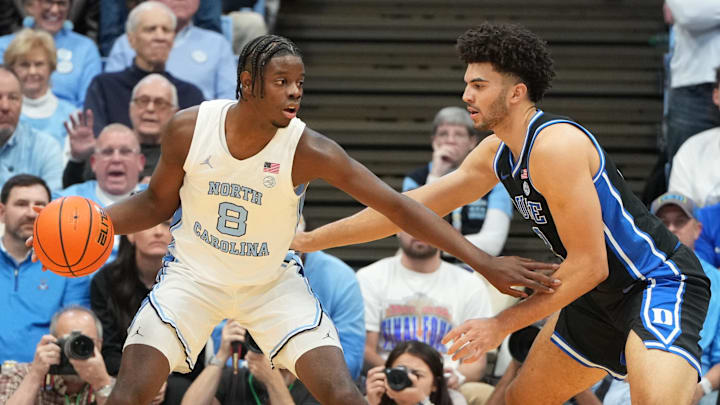Feb 7, 2026; Chapel Hill, North Carolina, USA; North Carolina Tar Heels forward Caleb Wilson (8) with the ball as Duke Blue Devils forward Cameron Boozer (12) defends in the first  half at Dean E. Smith Center.