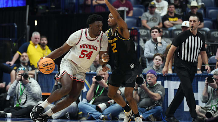 Mar 13, 2024; Nashville, TN, USA; Georgia Bulldogs center Russel Tchewa (54) drives to the basket against Missouri Tigers guard Tamar Bates (2) during the second half at Bridgestone Arena. Mandatory Credit: Christopher Hanewinckel-Imagn Images