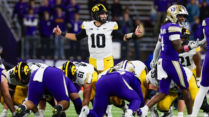 Oct 9, 2026; Seattle, Washington, USA; Iowa Hawkeyes quarterback Jeremy Hecklinski (10) stands over center before a fourth quarter play against the Washington Huskies at Husky Stadium. Mandatory Credit: Joe Nicholson-Imagn Images