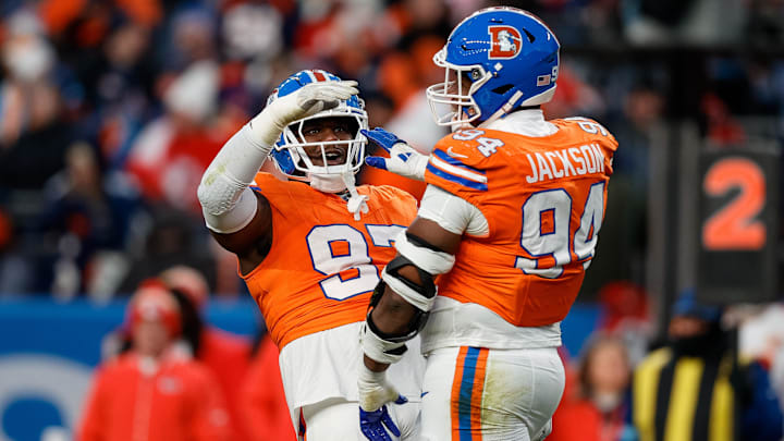 Jan 5, 2025; Denver, Colorado, USA; Denver Broncos defensive tackle Malcolm Roach (97) celebrates the sack of defensive tackle Jordan Jackson (94) in the fourth quarter against the Kansas City Chiefs at Empower Field at Mile High. Jan 5, 2025; Denver, Colorado, USA; Denver Broncos defensive tackle Malcolm Roach (97) celebrates the sack of defensive tackle Jordan Jackson (94) in the fourth quarter against the Kansas City Chiefs at Empower Field at Mile High.