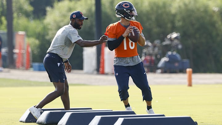 QB coach J.T. Barrett puts Caleb Williams through his paces prior to Wednesday's first practice.