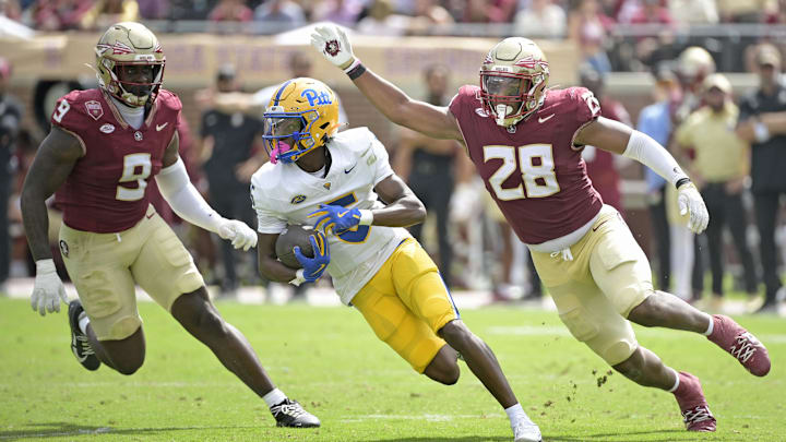 Oct 11, 2025; Tallahassee, Florida, USA; Pittsburgh Panthers wide receiver Raphael Williams Jr. (5) runs the ball up the field past Florida State Seminoles linebacker Omar Graham Jr. (9) and linebacker Justin Cryer (28) during the second half at Doak S. Campbell Stadium. Mandatory Credit: Melina Myers-Imagn Images