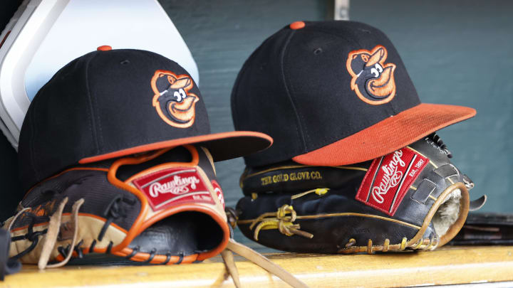 Apr 27, 2023; Detroit, Michigan, USA; Baltimore Orioles hats and glove sits in dugout in the second inning against the Detroit Tigers at Comerica Park. Apr 27, 2023; Detroit, Michigan, USA; Baltimore Orioles hats and glove sits in dugout in the second inning against the Detroit Tigers at Comerica Park.