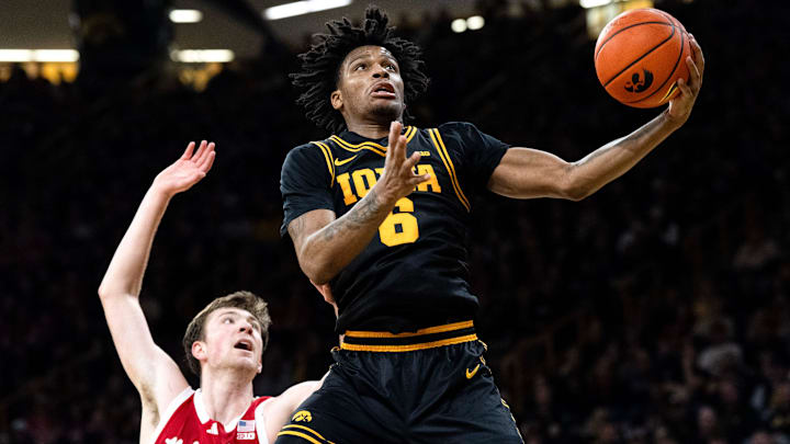 Iowa’s Tavion Banks (6) catches a pass as Nebraska forward Pryce Sandfort (21) defends Feb. 17, 2026 at Carver-Hawkeye Arena in Iowa City, Iowa.