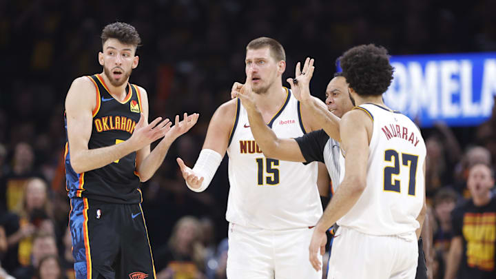 Oklahoma City Thunder forward Chet Holmgren and Denver Nuggets center Nikola Jokic react to a play.