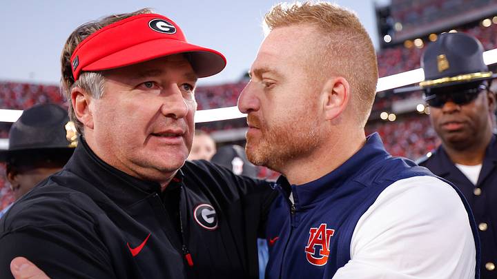 Coach Kirby Smart and Alex Golesh embrace.