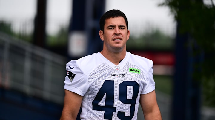 Jul 24, 2024; Foxborough, MA, USA; New England Patriots long snapper Joe Cardona (49) walks to the practice field during training camp at Gillette Stadium. Mandatory Credit: Eric Canha-Imagn Images