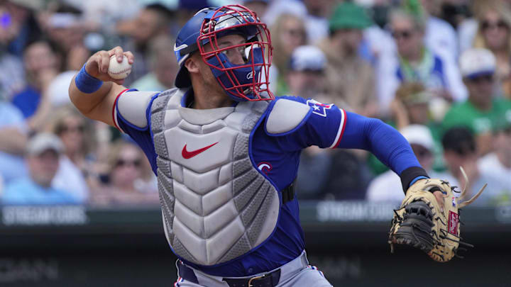 Mar 17, 2024; Mesa, Arizona, USA; Texas Rangers catcher Andrew Knizner (12) makes the play for an out against the Chicago Cubs in the third inning at Sloan Park. 