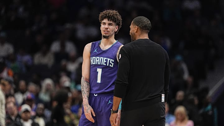 Mar 20, 2025; Charlotte, North Carolina, USA; Charlotte Hornets guard LaMelo Ball (1) talks with head coach Charles Lee  during a  free throw during the second half against the New York Knicks at Spectrum Center. Mandatory Credit: Jim Dedmon-Imagn Images