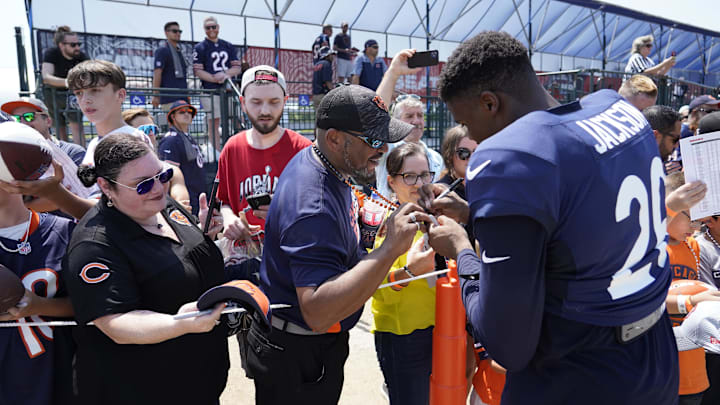 Bears receiver John Jackson signs autographs at training camp last year for fans following practice.