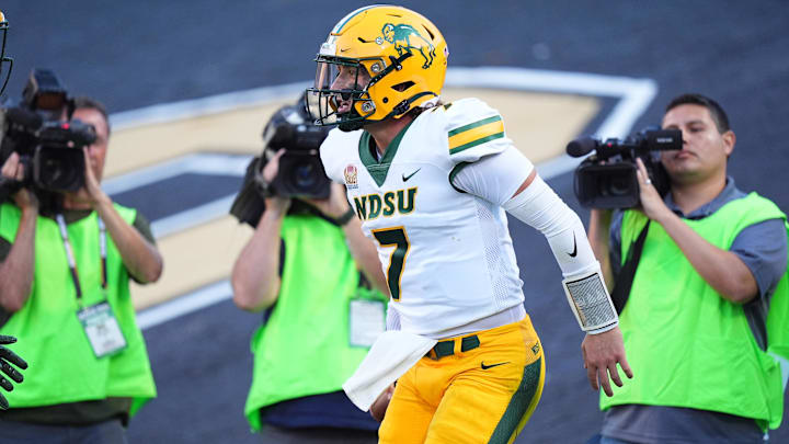 Aug 29, 2024; Boulder, Colorado, USA; North Dakota State Bison quarterback Cam Miller (7) celebrates his rushing touchdown in the second quarter against the Colorado Buffaloes at Folsom Field. Mandatory Credit: Ron Chenoy-Imagn Images