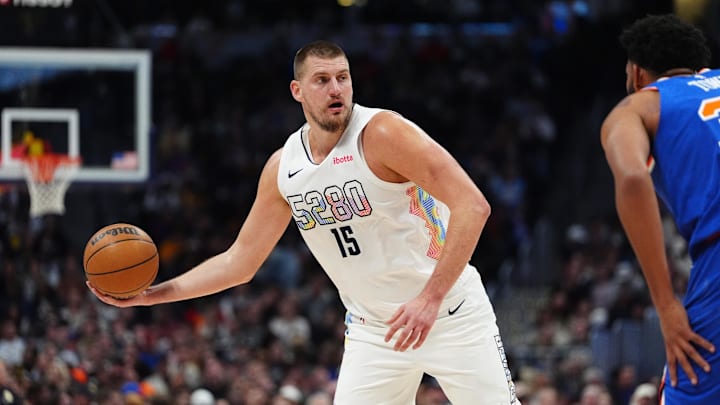 Nov 25, 2024; Denver, Colorado, USA; Denver Nuggets center Nikola Jokic (15) controls the ball in the first quarter against the New York Knicks at Ball Arena. Mandatory Credit: Ron Chenoy-Imagn Images