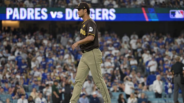 Oct 11, 2024; Los Angeles, California, USA; San Diego Padres pitcher Yu Darvish (11) reacts after a solo home run by Los Angeles Dodgers outfielder Teoscar Hernandez (not pictured) in the seventh inning during game five of the NLDS for the 2024 MLB Playoffs at Dodger Stadium. Mandatory Credit: Jayne Kamin-Oncea-Imagn Images