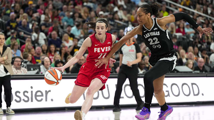 Jun 22, 2025; Las Vegas, Nevada, USA; Indiana Fever guard Caitlin Clark (22) dribbles the ball against Las Vegas Aces center A'ja Wilson (22) during the second half of a WNBA basketball game at T-Mobile Arena. Mandatory Credit: Lucas Peltier-Imagn Images