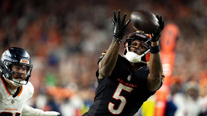 Cincinnati Bengals wide receiver Tee Higgins (5) catches a pass inside the 5-yard line as Denver Broncos cornerback Riley Moss (21) defends in overtime of the NFL game at Paycor Stadium in Cincinnati on Saturday, Dec. 28, 2024.