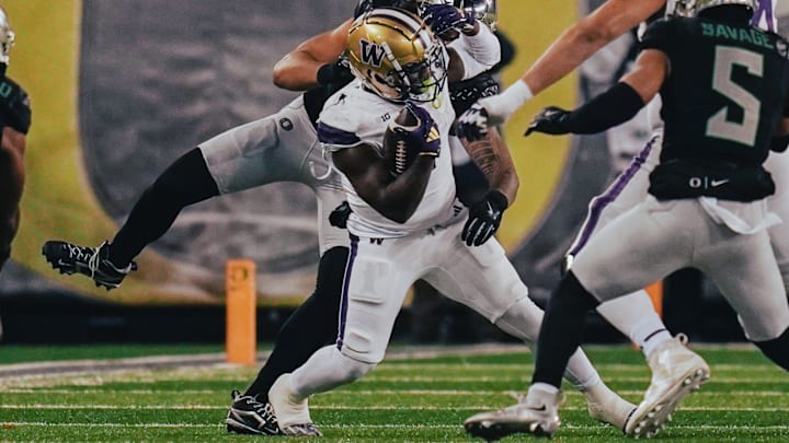 Jonah Coleman gets twisted around by the Oregon defense. Jonah Coleman gets twisted around by the Oregon defense.