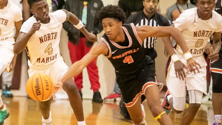 North Marion High School guard Titus Williams (4) tries to catch Umatila guard Herly Brutus (4) as North Marion takes on Umatilla during the 2023 4A FHSAA Boys Basketball State Tournament  Thursday, Feb. 16, 2023, at North Marion High School in Citra, Fla. North Marion won 74-37.[Alan Youngblood/Ocala Star-Banner]

Oca Nm Vs Umatilla 00724963
