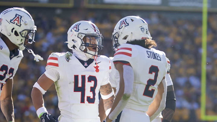 Nov 25, 2023; Tempe, Arizona, USA; Arizona Wildcats safety Dalton Johnson (43) celebrates a play with cornerback Treydan Stukes (2) against the Arizona State Sun Devils during the Territorial Cup at Mountain America Stadium. Mandatory Credit: Mark J. Rebilas-USA TODAY Sports