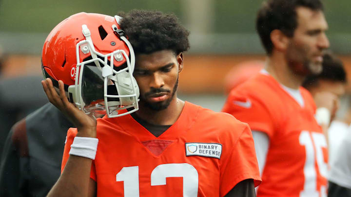 Cleveland Browns quarterback Shedeur Sanders (12) listens to the play calling on the sideline during an NFL practice at the Cleveland Browns training facility on Wednesday, May 28, 2025, in Berea, Ohio.
