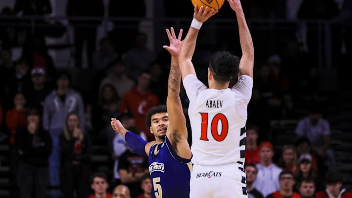 Nov 16, 2025; Cincinnati, Ohio, USA; Mount St. Mary's Mountaineers forward Trey Deveaux (5) guards against Cincinnati Bearcats guard Shon Abaev (10) in the second half at Fifth Third Arena. Mandatory Credit: Katie Stratman-Imagn Images