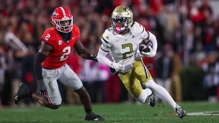 Nov 29, 2024; Athens, Georgia, USA; Georgia Tech Yellow Jackets wide receiver Eric Singleton Jr. (2) runs past Georgia Bulldogs linebacker Smael Mondon Jr. (2) in the first quarter at Sanford Stadium. Mandatory Credit: Brett Davis-Imagn Images
