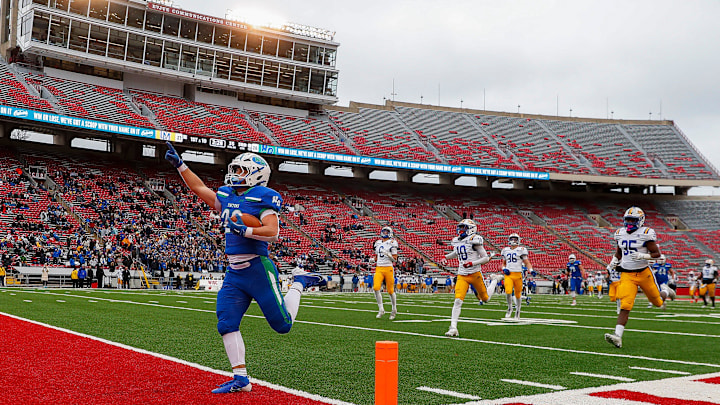 Notre Dame Academy's Christian Collins (22) points to the sky as he crosses the goal line for a 73-yard touchdown on the final play of the third quarter against Catholic Memorial High School during the WIAA Division 3 state championship game on Friday, November 22, 2024, at Camp Randall Stadium in Madison, Wisconsin.