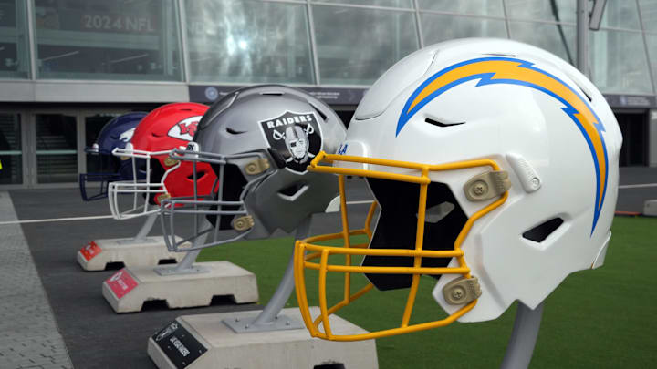 Oct 13, 2024; London, United Kingdom; Large helmets of the Los Angeles Chargers, Las Vegas Raiders, Kansas City Chiefs and Denver Broncos of the AFC West before an NFL International Series game at Tottenham Hotspur Stadium. Mandatory Credit: Kirby Lee-Imagn Images