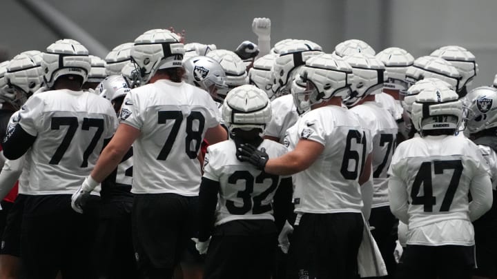Jul 31, 2023; Henderson, NV, USA; Las Vegas Raiders wearing Guardian helmet caps huddle during training camp at the Intermountain Health Performance Center. Mandatory Credit: Kirby Lee-USA TODAY Sports