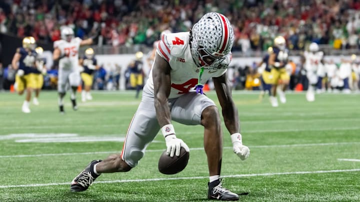 Jan 20, 2025; Atlanta, GA, USA; Ohio State Buckeyes wide receiver Jeremiah Smith (4) celebrates a play against the Notre Dame Fighting Irish during the CFP National Championship college football game at Mercedes-Benz Stadium. Mandatory Credit: Mark J. Rebilas-Imagn Images