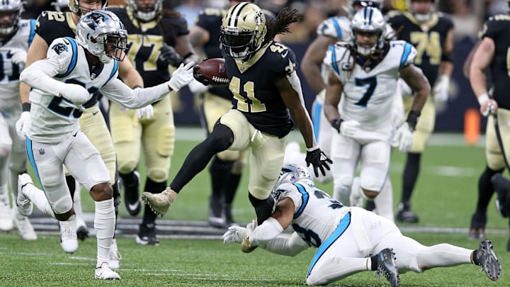 New Orleans Saints running back Alvin Kamara (41) runs through a crease against the Carolina Panthers 