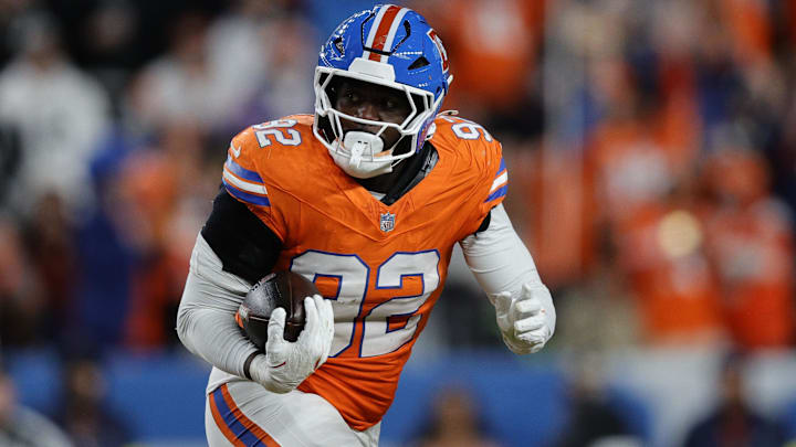 Nov 6, 2025; Denver, Colorado, USA; Denver Broncos linebacker Dondrea Tillman (92) runs with the ball after an interception against the Las Vegas Raiders during the second half at Empower Field at Mile High. 