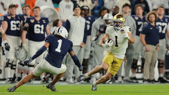 Jan 9, 2025; Miami, FL, USA; Notre Dame Fighting Irish wide receiver Jaden Greathouse (1) runs the ball in the second half against the Penn State Nittany Lions in the Orange Bowl at Hard Rock Stadium. 