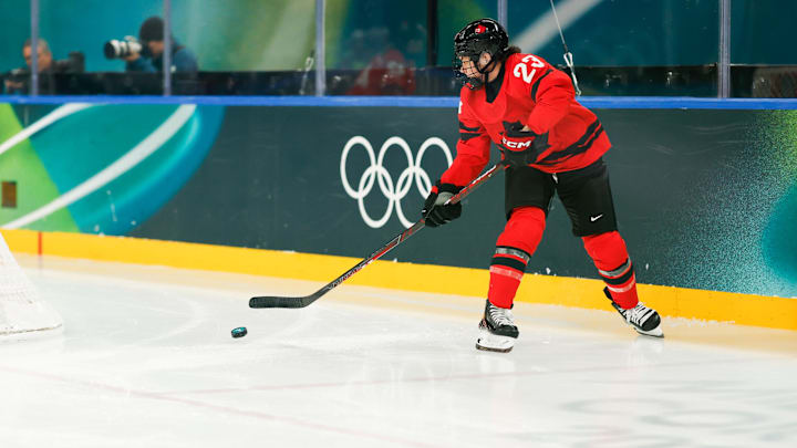 Feb 16, 2026; Milan, Italy; Erin Ambrose (23) of Canada skates with the puck during the first period against Switzerland in a women's ice hockey semifinal during the Milano Cortina 2026 Olympic Winter Games at Milano Santagiulia Ice Hockey Arena. Mandatory Credit: Geoff Burke-Imagn Images