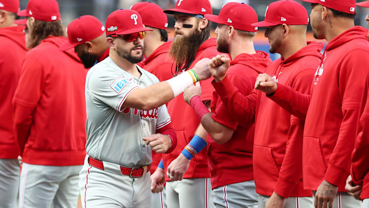 Oct 8, 2024; New York City, New York, USA; Philadelphia Phillies designated hitter Kyle Schwarber (12) greets teammates before game three against the New York Mets in the NLDS for the 2024 MLB Playoffs at Citi Field. 