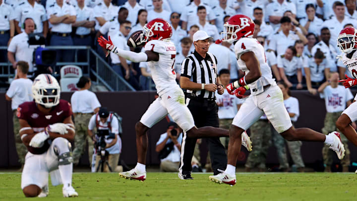 Sep 21, 2024; Blacksburg, Virginia, USA; Rutgers Scarlet Knights defensive back Robert Longerbeam (7) celebrates after making an interception during the fourth quarter against the Virginia Tech Hokies at Lane Stadium. Mandatory Credit: Peter Casey-Imagn Images