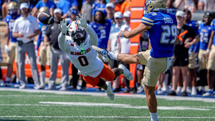 Tulsa punter Angus Davies (29) punts the ball as Oklahoma State safety Kobe Hylton (0) attempts the block in the first half during an NCAA football game between Oklahoma State and Tulsa in Tulsa, Okla., on Saturday, Sept. 14, 2024.