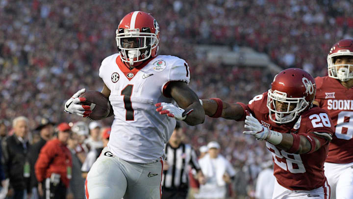 Jan 1, 2018; Pasadena, CA, USA; Georgia Bulldogs running back Sony Michel (1) is pursued by Oklahoma Sooners safety Chanse Sylvie (28) on a 38-yard touchdown run in the third quarter in the 2018 Rose Bowl college football playoff semifinal game at Rose Bowl Stadium. Georgia defeated Oklahoma 54-48 in two overtimes. Mandatory Credit: Kirby Lee-Imagn Images Jan 1, 2018; Pasadena, CA, USA; Georgia Bulldogs running back Sony Michel (1) is pursued by Oklahoma Sooners safety Chanse Sylvie (28) on a 38-yard touchdown run in the third quarter in the 2018 Rose Bowl college football playoff semifinal game at Rose Bowl Stadium. Georgia defeated Oklahoma 54-48 in two overtimes. Mandatory Credit: Kirby Lee-Imagn Images
