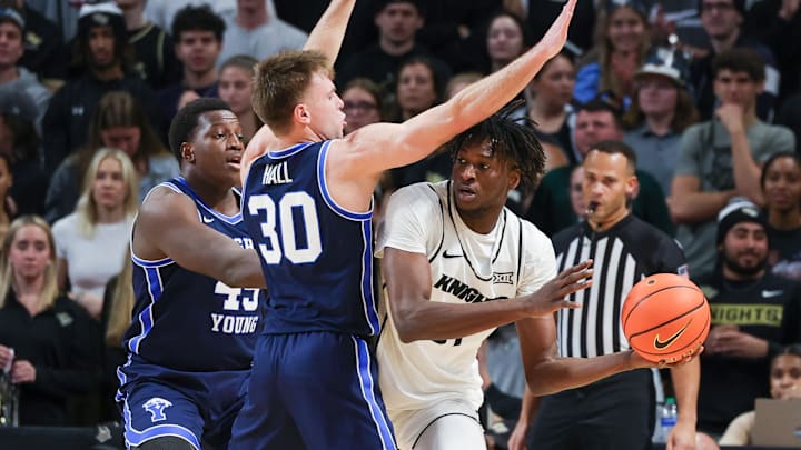 Jan 13, 2024; Orlando, Florida, USA; UCF Knights forward Thierno Sylla (31) looks to pass against Brigham Young Cougars guard Dallin Hall (30) during the first period at Addition Financial Arena. Mandatory Credit: Mike Watters-Imagn Images